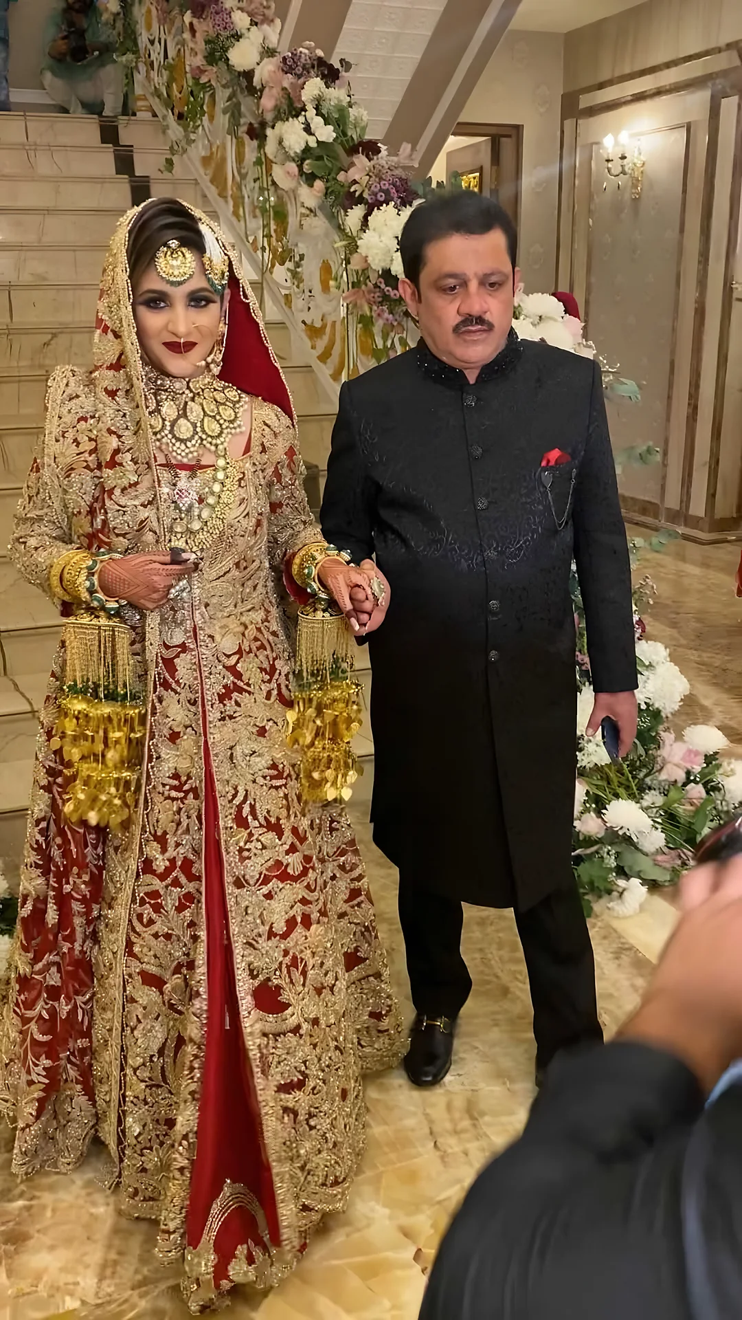 Bride in red with her father