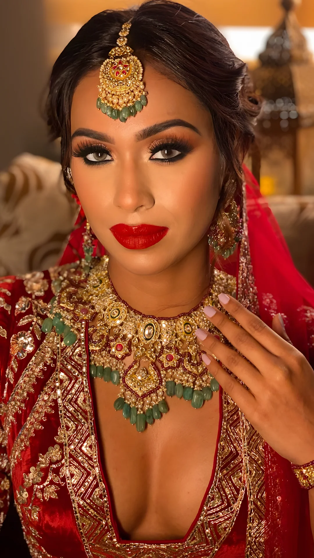Bride in red with emerald jewellery