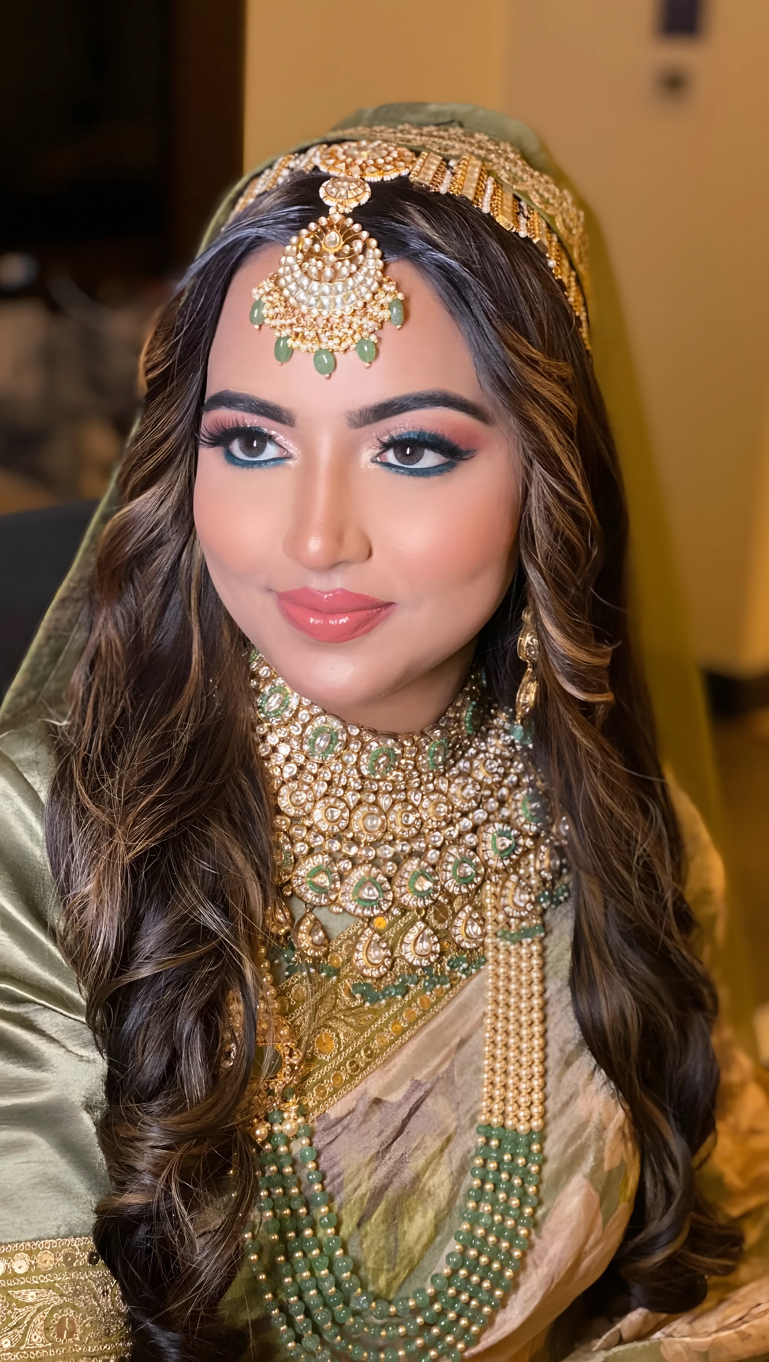 Bride with soft waves and gold jewellery, makeup by Zohara Shereen